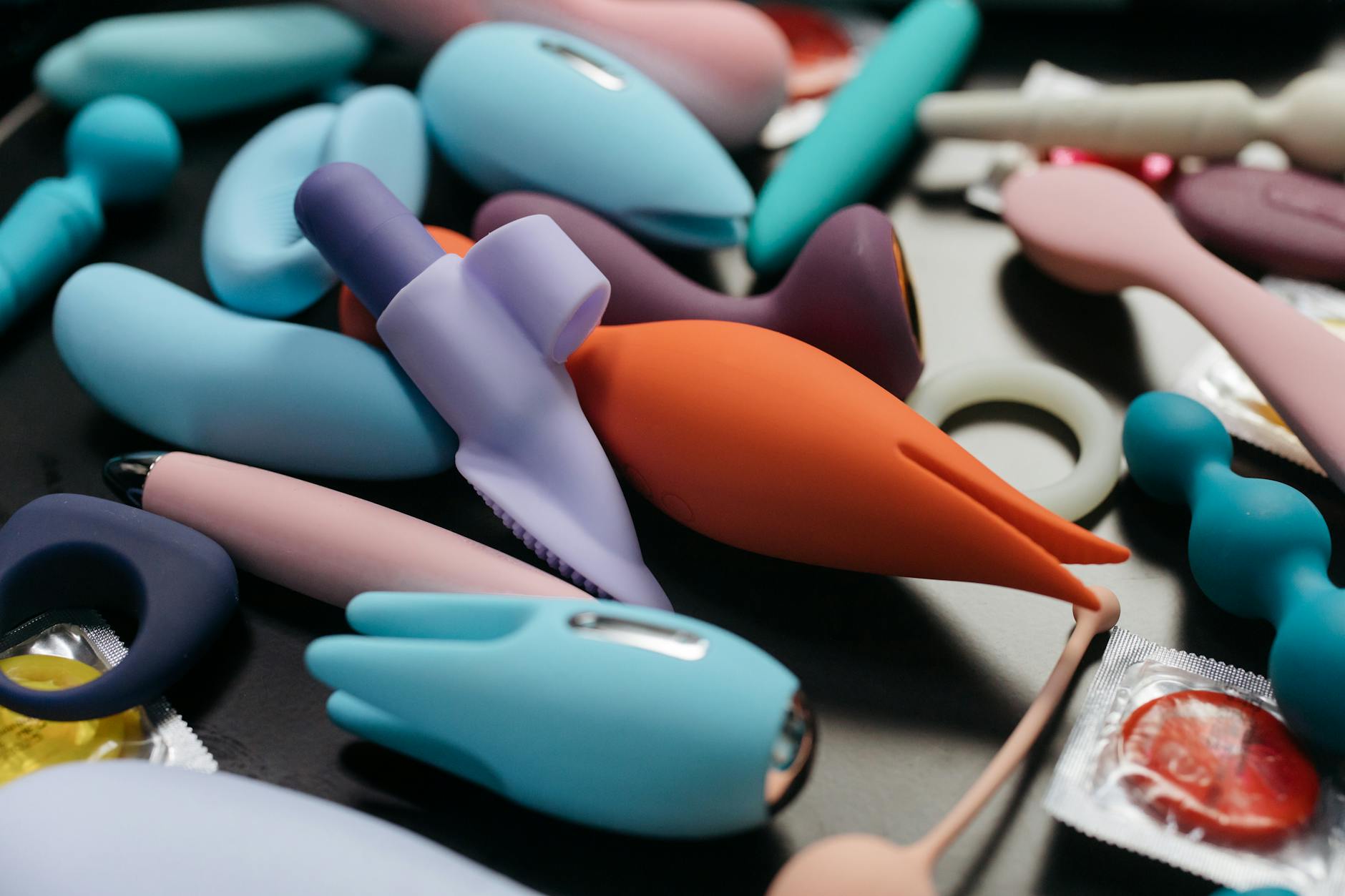 Assorted vibrators and clitoral toys in varying colors and textures