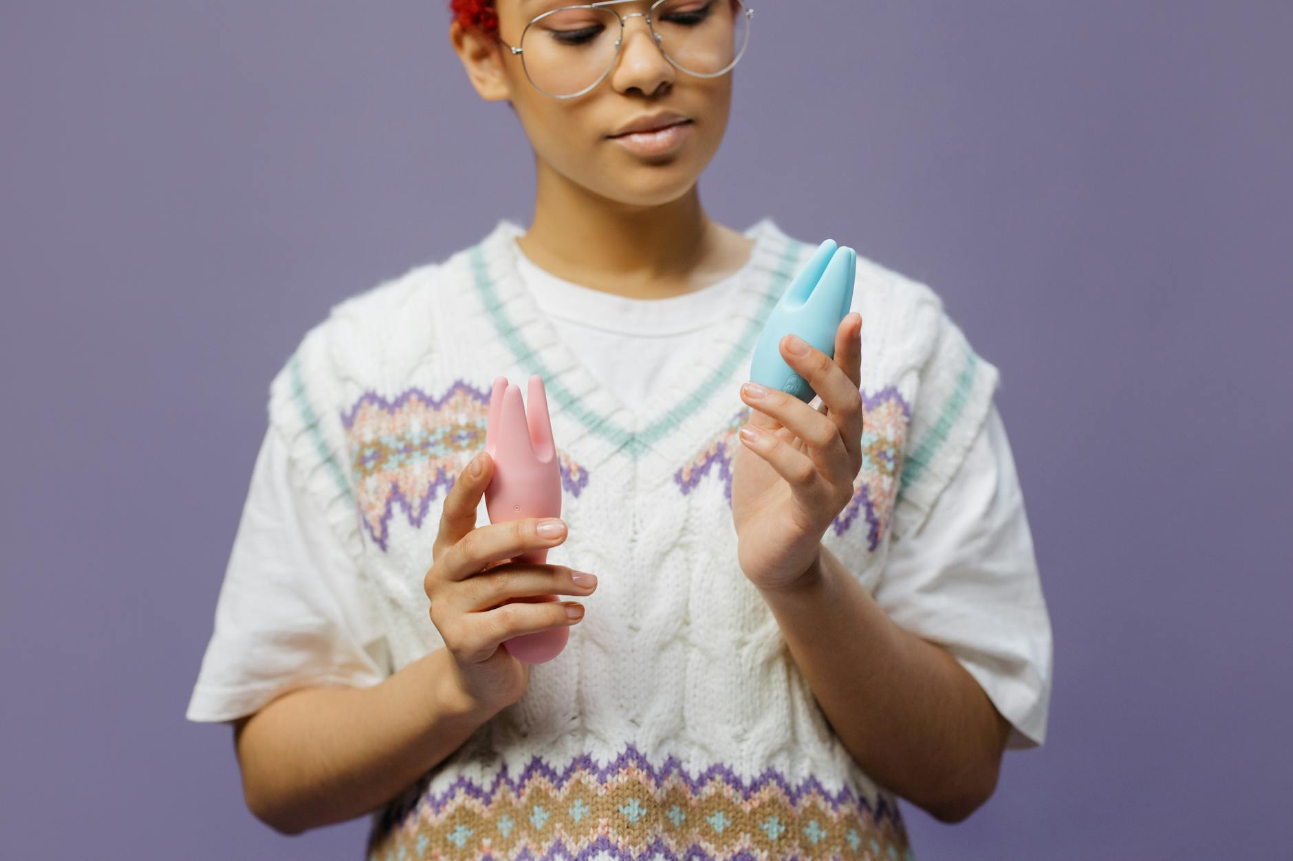 Woman holding different colored silicone vibrators in her hands, representing the range of sensations available after hormone changes