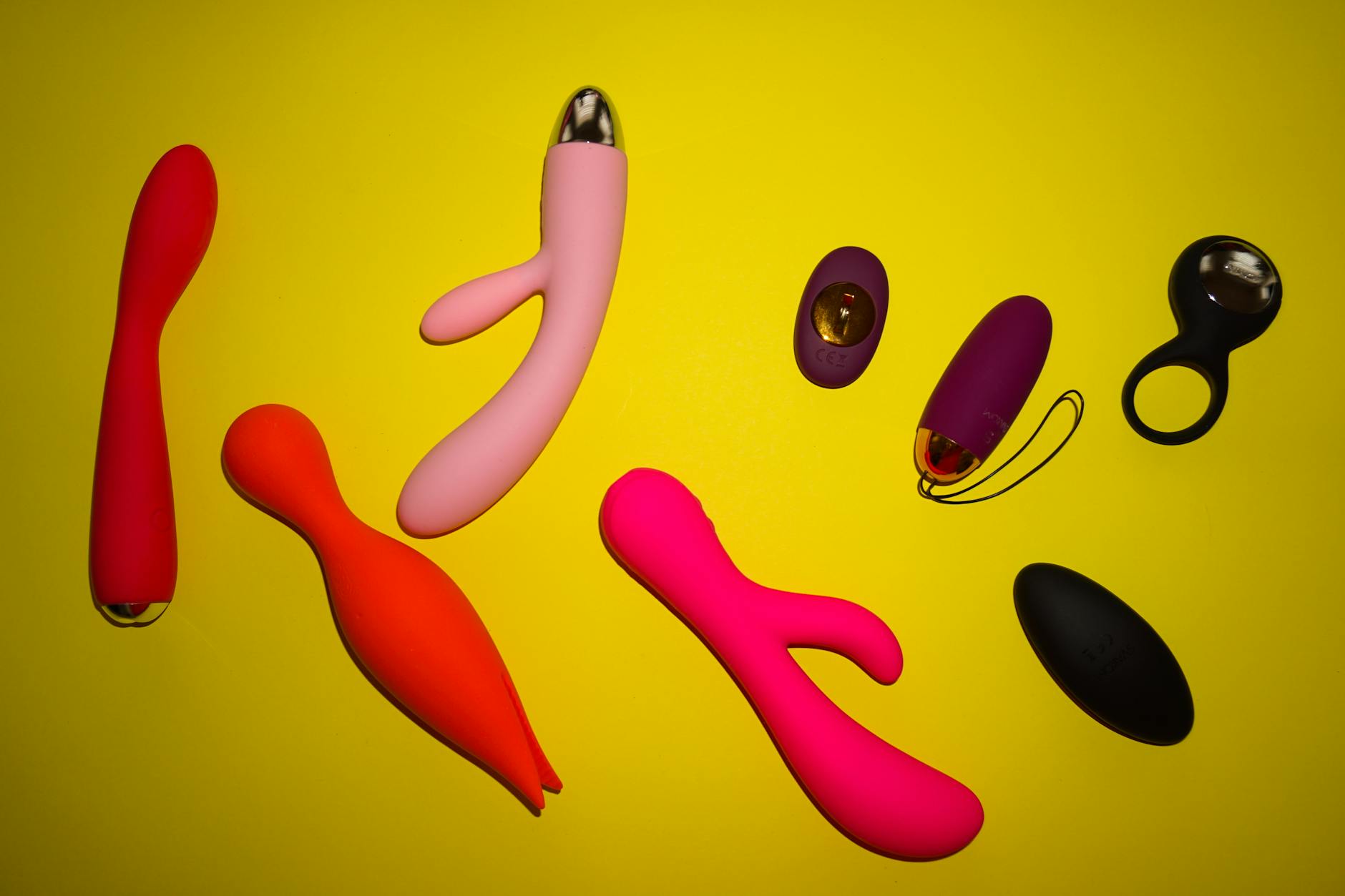 Hand holding a lemon vibrator against purple background, promoting relaxation and pleasure