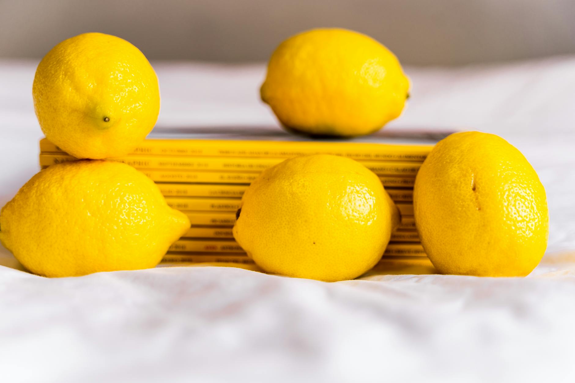 Yellow silicone lemon vibrator surrounded by peeled bananas on a yellow background